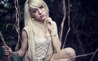 Woman branch forest blonde serious - her face and shoulder free wallpaper