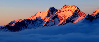 Snowy mountain sunset clouds pink - a few cloud below free wallpaper