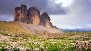 Mountain range rocks grass cloudy - romanesque free wallpaper