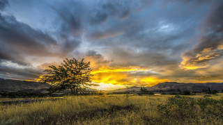 Sunset mountains tree field clouds - hue free wallpaper