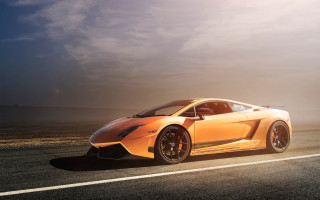 Yellow sports car cloudy sky 7 - a sunbeam in the background free wallpaper