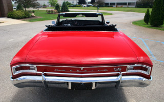 Red car parked next to - a driveway free wallpaper