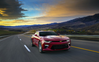 Red car mountains sunset beach - a red car free wallpaper