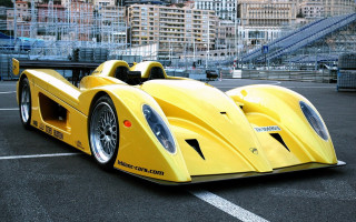Yellow racecar cityscape night moon - a parking lot in front free wallpaper