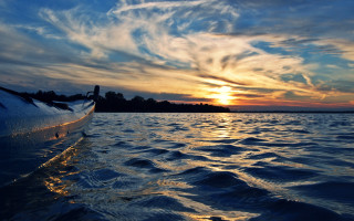 Sunset boat water island sky - a small island in the distance free wallpaper
