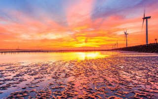 Sunset windmills colorful sky water - low free wallpaper