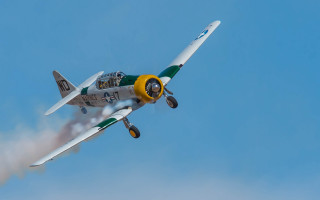 Small airplane blue sky smoke - f 8 aperture free wallpaper