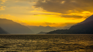 Sunset mountains boat water yellow - a yellow sky free wallpaper