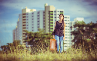 Woman brownbag field city background - tall grass free wallpaper
