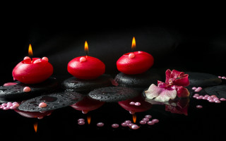 Candles rocks flowers beads stilllife - top of a table next free wallpaper