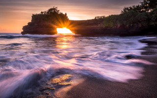 Sunset beach waves rocks island - a rock formation free wallpaper