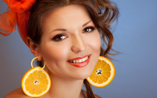 Orange slices earrings woman smiling - orange free wallpaper