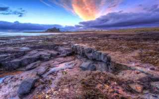 Rocky beach island cloudy sunset - a sunset in the distance free wallpaper for desktop