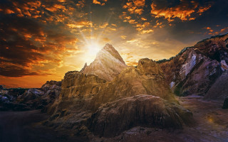 Mountain sunset clouds fire embers 2 - a sun setting behind free wallpaper