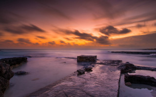 Sunset rocky beach jetty dusk - a long exposure of a sunset over a rocky beach free wallpaper