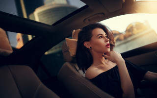 Woman sitting car sky buildings - her chin free wallpaper