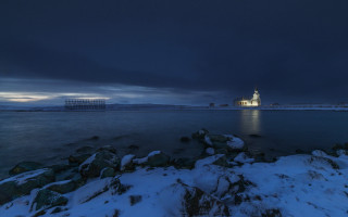 Lighthouse snowy shore night dark - a lighthouse free wallpaper