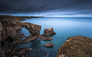 Lake bridge rocks sky mountains - a dark sky above free wallpaper
