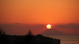 Sunset building mountain orange sky - free sunset wallpaper