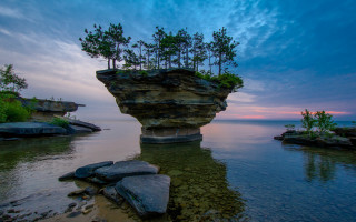Rock formation water trees sunset - a rock formation free wallpaper