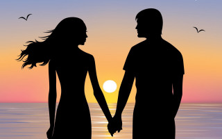 Beach sunset couple holding hands - the sun setting behind them free wallpaper