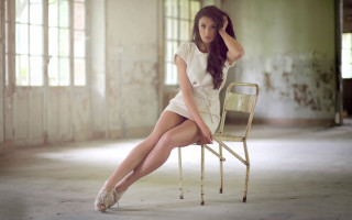 Woman sitting room window tilt - a window behind her free wallpaper