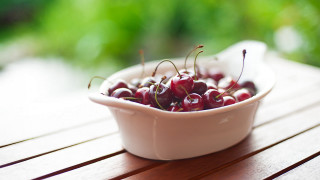 Bowl cherries outdoor wooden table - a wooden table outside free wallpaper