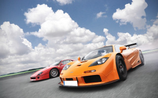 Orange sports cars cloudy track - motion blur free wallpaper