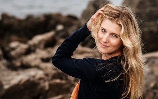 Woman longhair rocks water smiling - christabel dennison free wallpaper