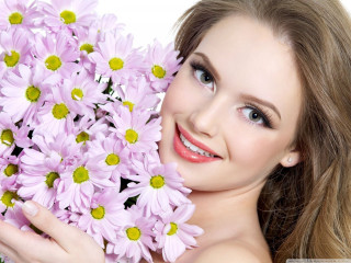 Woman holding flowers smiling camera 2 - facial free wallpaper