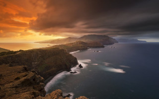 Sunset coastline mountains water clouds - a body of water and mountains free wallpaper
