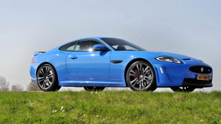 Blue sports car grassy hill - a green grass field free wallpaper