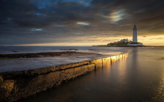 Lighthouse rocky shore sunset water 6 - dramatic light free wallpaper