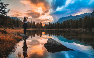 Woman lake sunset clouds rock - alena aenami free wallpaper