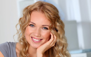 Blonde woman smiling hand on - facial feature free wallpaper