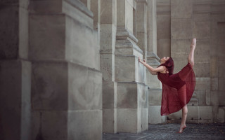 Woman red dress stretching wall - against a wall free wallpaper