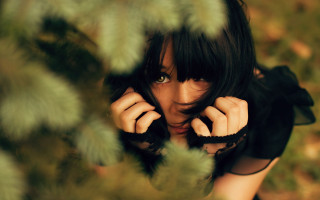 Black dress woman posing foliage - her eye wide open free wallpaper