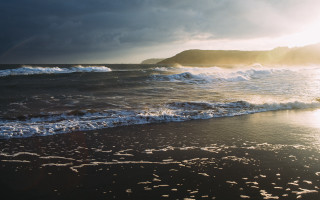 Beach waves rainbow mountain ocean - a mountain in the distance free wallpaper
