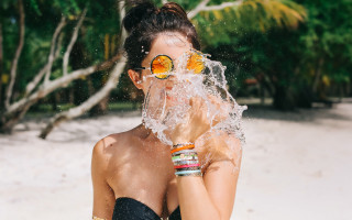 Woman splashing water summer christmas - sunglass free wallpaper