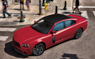 Red car sidewalk people building - a red car free wallpaper
