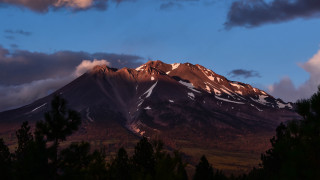 Mountain snow capped trees sunset - dramatic light free wallpaper