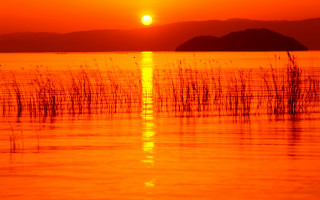 Sunset water boat mountain orange - orange sky free wallpaper
