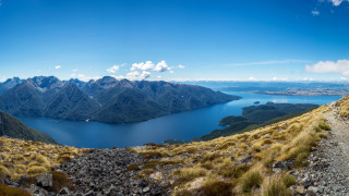 Mountain lake panorama blue sky 2 - a view of a mountain range free wallpaper for desktop