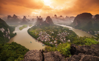 River mountains village sunset cloudy - mountain under a cloudy sky free wallpaper