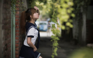 Girl ponytail brick wall school - a school uniform free wallpaper