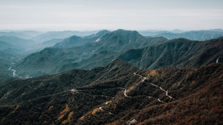 Mountain range winding road sunset 2 - road in the middle of it free wallpaper