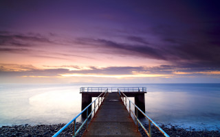 Pier rail ocean sunset clouds - moody free wallpaper