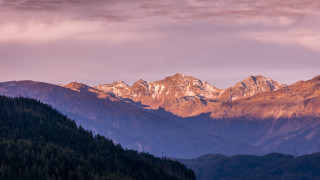 Mountain range trees pink sky 2 - a pink sky in the background free wallpaper