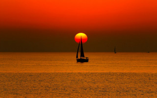 Sailboat ocean sunset redsky yellowsun - a sailboat free wallpaper