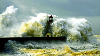 Lighthouse wave stormy ocean impressionist - a lighthouse in the background free wallpaper